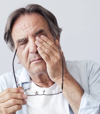 Old man with eye fatigue
